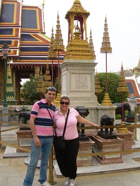 Couple beside elephant statues and golden stupas at the Grand Palace, Bangkok