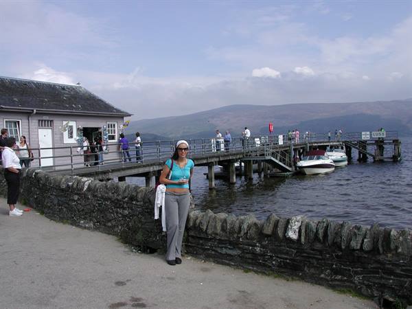 Woman in blue top beside a stone wall on Loch Lomond pier