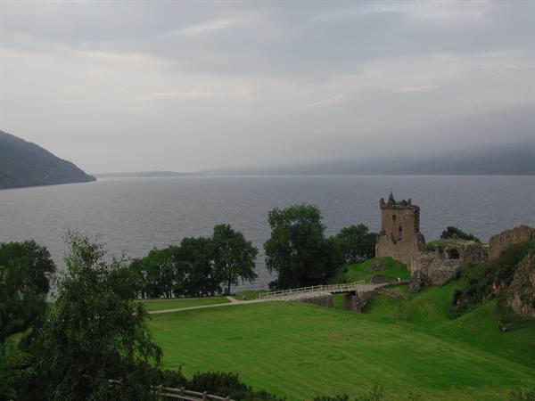 Urquhart Castle on the shores of Loch Ness under a grey sky