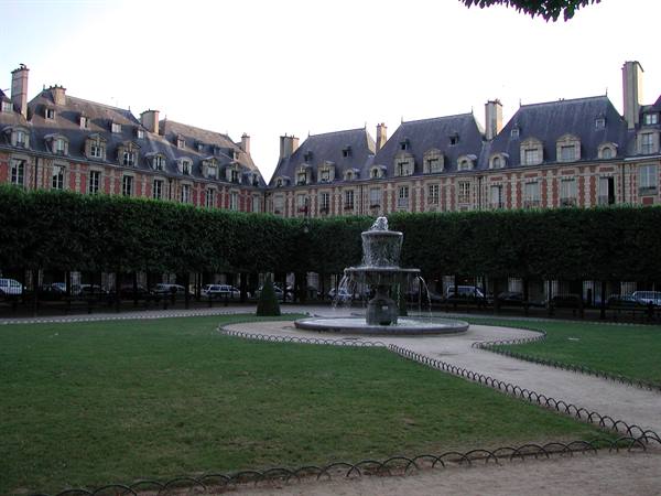 Stone fountain in the garden courtyard of Place des Vosges, Paris