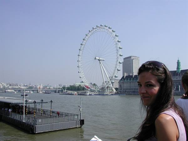 Smiling girl in front of the London Eye and the Thames