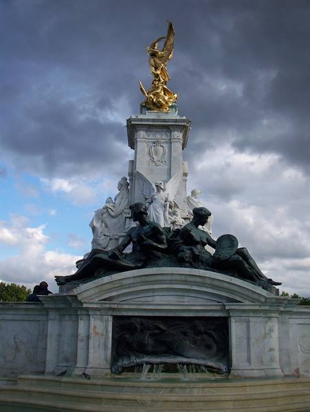 Victoria Memorial in London: white marble, bronze figures and golden angel under cloudy sky