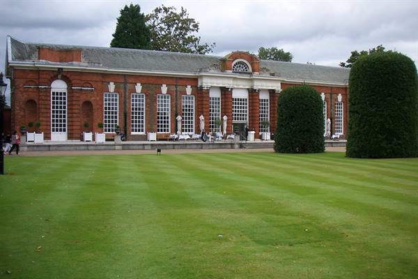 Red brick facade with tall white windows facing a manicured lawn, Kensington Palace