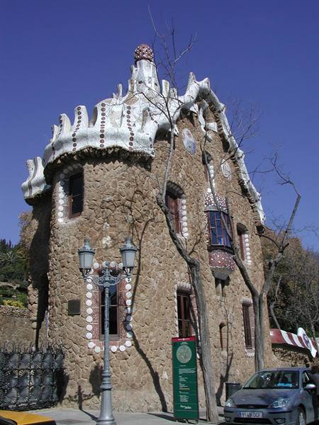 Stone house with wavy white mosaic roof by Gaudí, Parc Güell, Barcelona