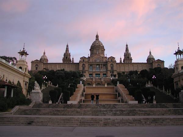 Two people climb the steps toward the Museu Nacional d'Art de Catalunya in Barcelona