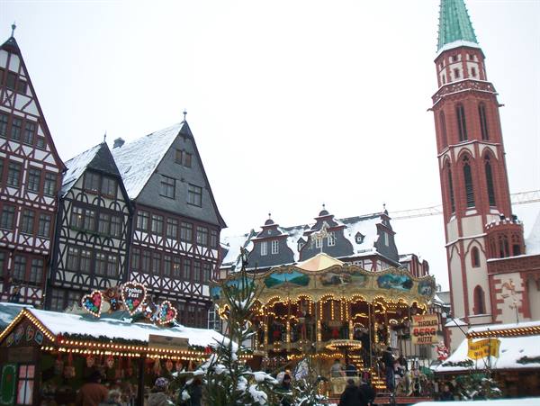 Snowy Christmas market with illuminated carousel, Römerberg, Frankfurt