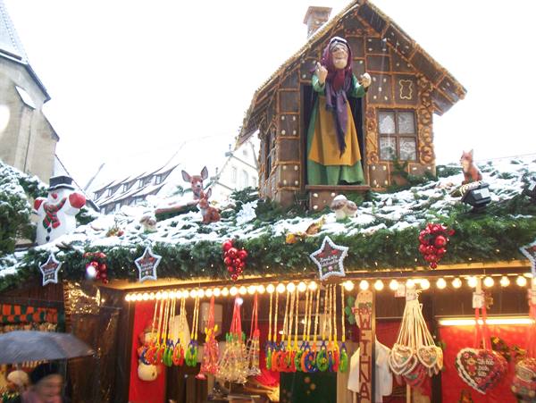 Nuremberg Christmas market stall with snowman, gingerbread house and snowy decorations