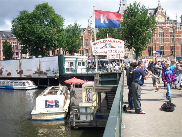 Tourists near Amsterdam Centraal station by the Rondvaart boat dock