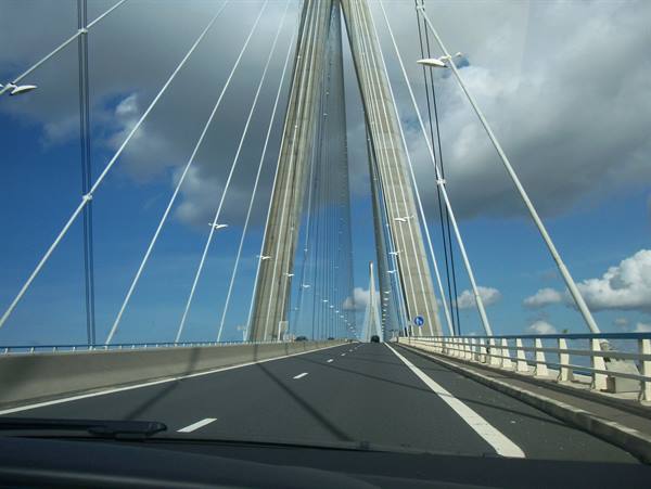 Driving across the Pont de Normandie among steel cables under a cloudy sky