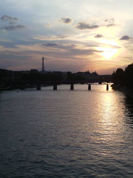 The Seine in Paris with the Eiffel Tower and a bridge at sunset