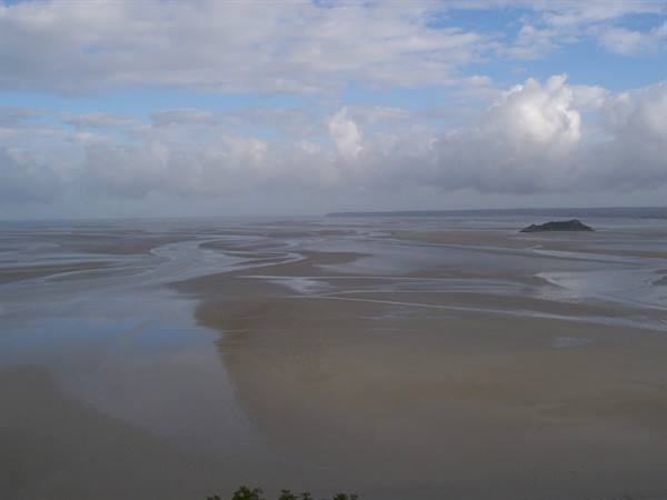 Wide tidal flats exposed at low tide in Mont-Saint-Michel bay