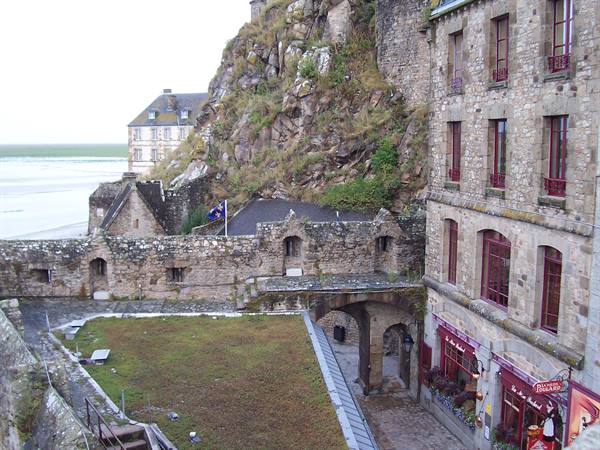 Stone walls and medieval houses beneath the Mont Saint-Michel rock