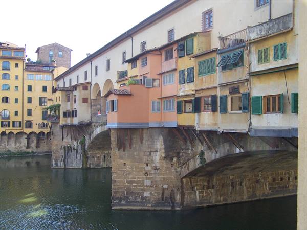 Ponte Vecchio in Florence, colorful houses on stone arches above the Arno