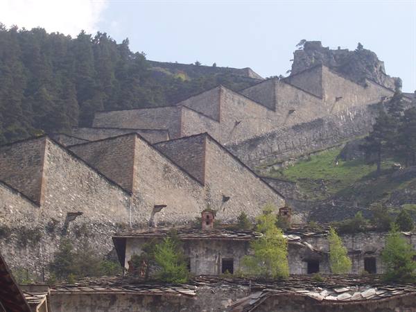 Zigzag walls of Fenestrelle Fort climb the wooded mountainside