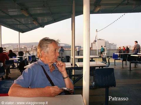 Woman thinking at a ferry deck table, sailing to Patras