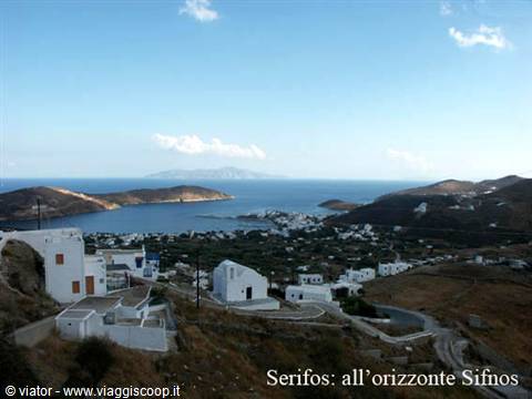 Whitewashed Serifos houses on the hill, blue sea and Sifnos in the distance