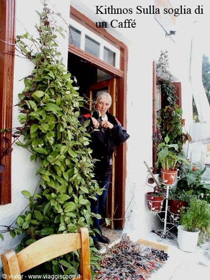 Kithnos, elderly woman at a café doorway among climbing plants and pots