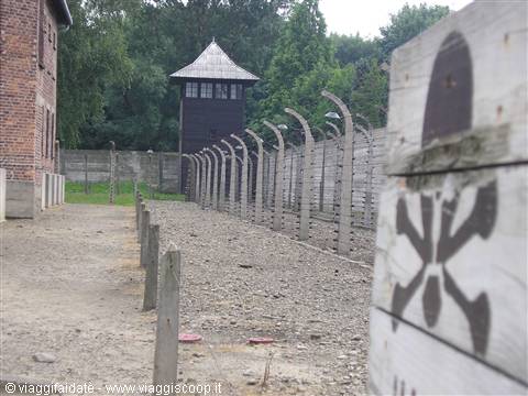 Wooden guard tower and electrified fence with skull sign, Auschwitz I