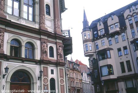 Art Nouveau buildings with statues and tapered tower in Riga