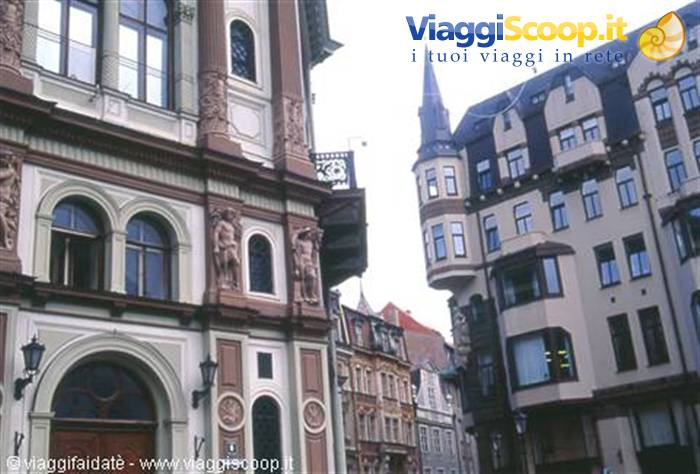 Art Nouveau buildings with statues and tapered tower in Riga