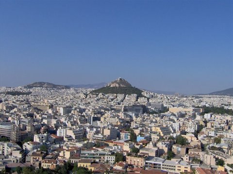 Athens under a blue sky, with Mount Lycabettus in the center