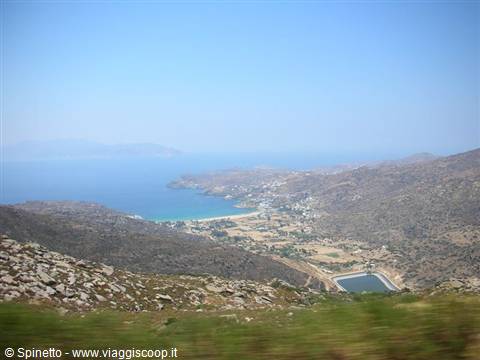 Turquoise bay between arid hills and salt pans, Greek islands under blue sky