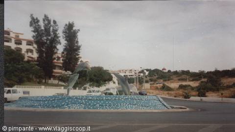 Roundabout fountain with dolphin sculpture on blue mosaic, Albufeira