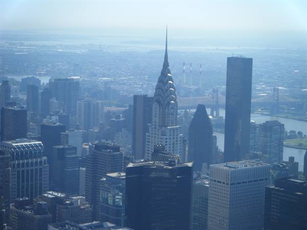 Manhattan skyscrapers with the Chrysler Building spire under haze
