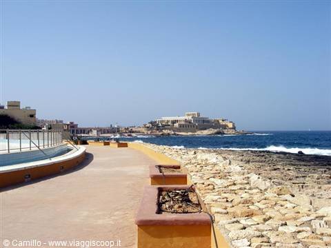 Sliema promenade, Malta: stone walkway beside rocky shores hit by waves