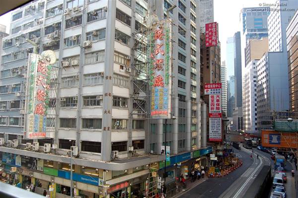 Vertical neon signs on Hong Kong buildings above the busy street