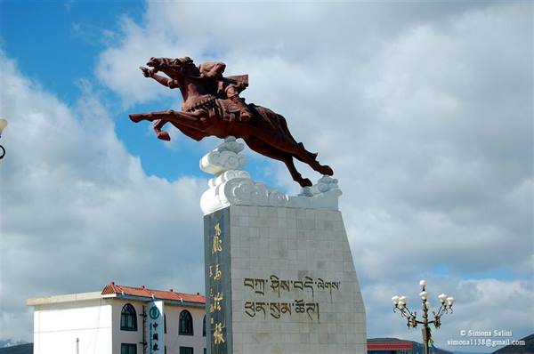 Statue of a galloping horse on marble pillar with Tibetan inscriptions
