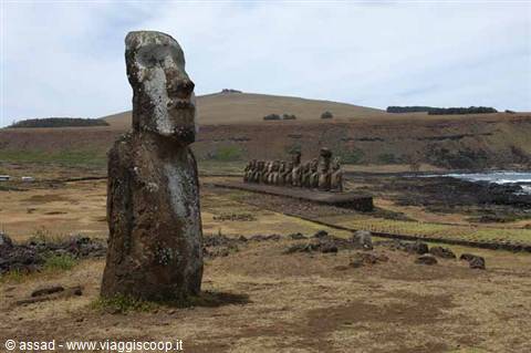 Lone moai before the Ahu Tongariki row, carved volcanic figures under a grey sky