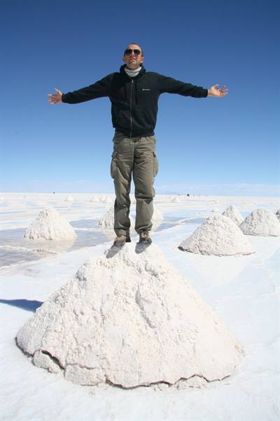 Man standing on a salt mound at Salar de Uyuni