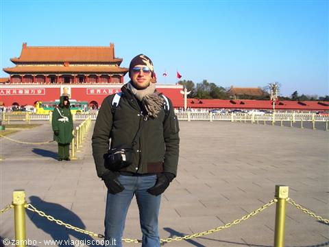 Tourist with camera in Tiananmen Square, Gate of Heavenly Peace behind