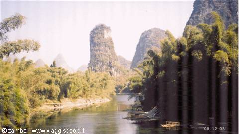 Li River in Guilin, boats among bamboo groves and karst peaks in daylight