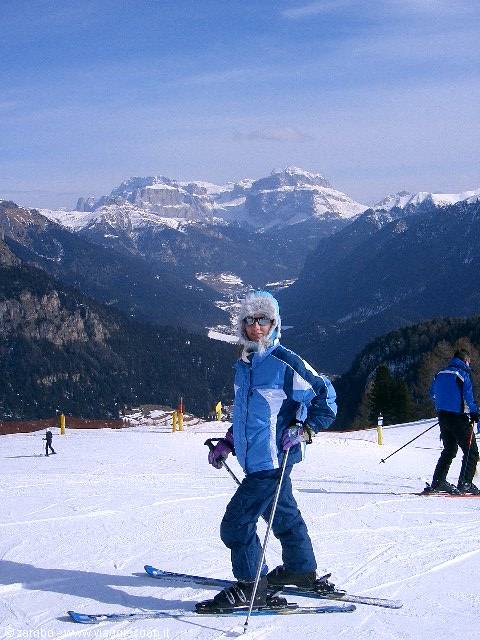 Skier in blue suit on snowy slopes of the Dolomites