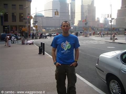 Young man in a blue t-shirt on a Lower Manhattan sidewalk, New York