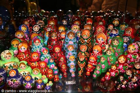 Stall of colorful painted wooden matryoshka dolls in a lit shop window