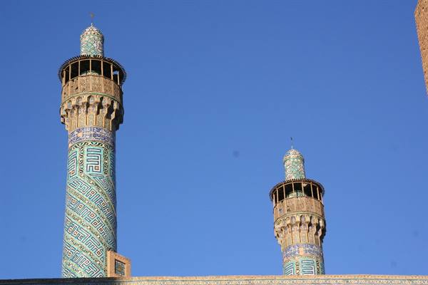 Tiled minarets of the Shah Mosque, Isfahan, under blue sky