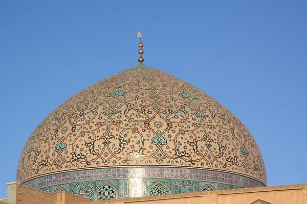 Tiled dome of Sheikh Lotfollah Mosque in Isfahan under blue sky