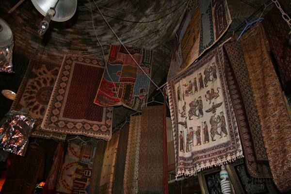 Carpets hanging in Esfahan bazaar beneath a brick vault