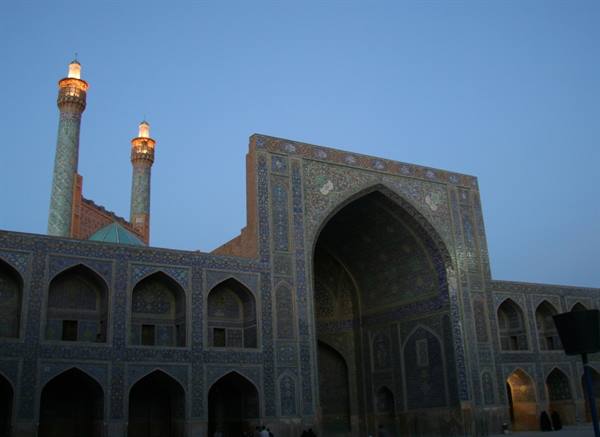 Shah Mosque in Esfahan, blue tiles and minarets glowing at dusk