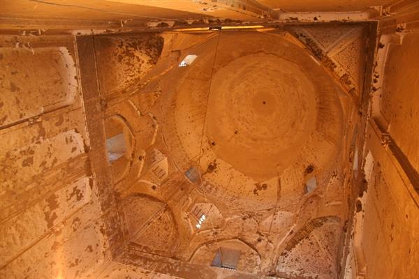 Brick dome with muqarnas squinches, weathered interior, light through small windows