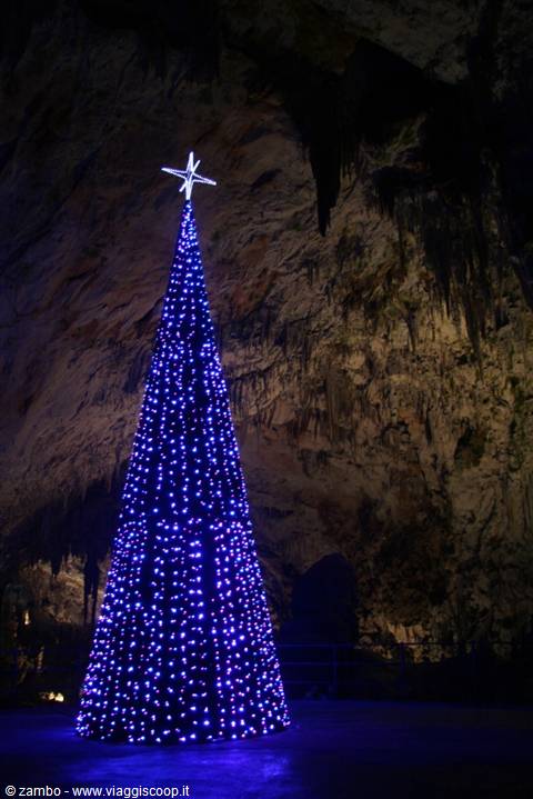 Blue illuminated Christmas tree inside a cave with stalactites