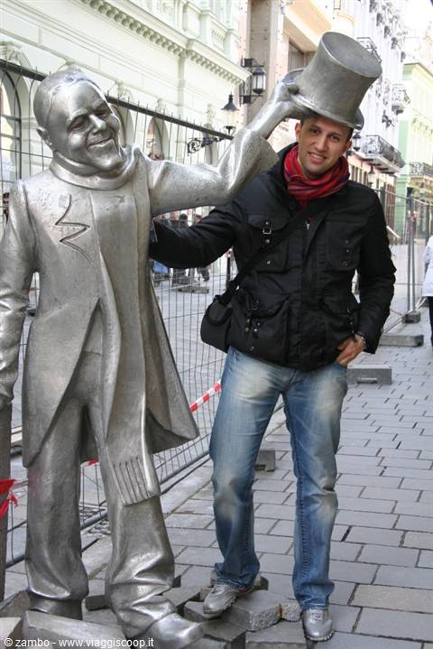 Tourist beside the Schöne Náci metal statue in central Bratislava