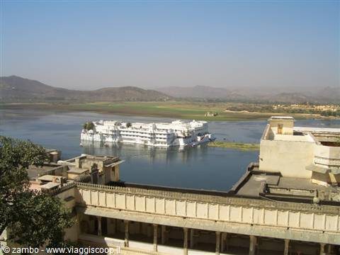 The white Lake Palace floats on Pichola lake, seen from Udaipur rooftops
