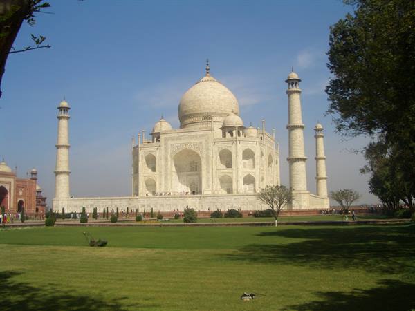 The white marble Taj Mahal with minarets among green gardens, Agra