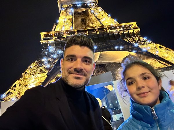 Selfie under the illuminated Eiffel Tower: Parisian magic all for us.