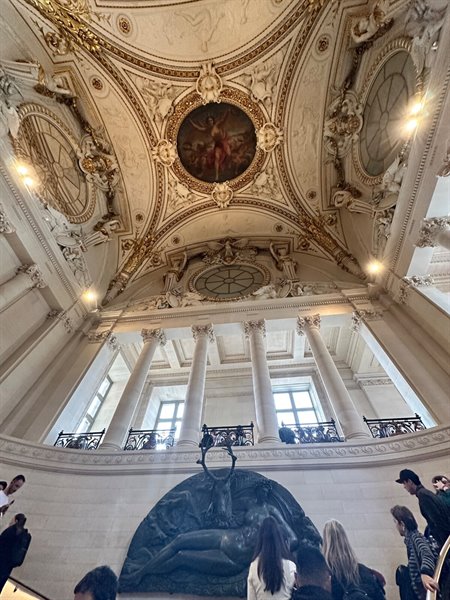 Head upside down on the Louvre's grand staircase, pure wonder.