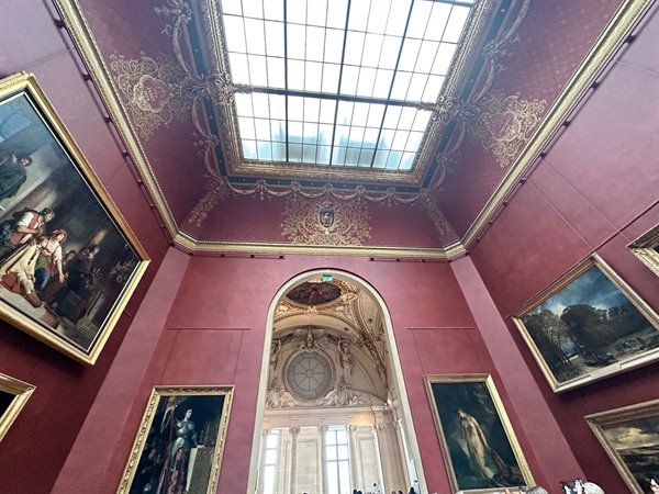 Louvre room: the ceiling light illuminates timeless masterpieces.